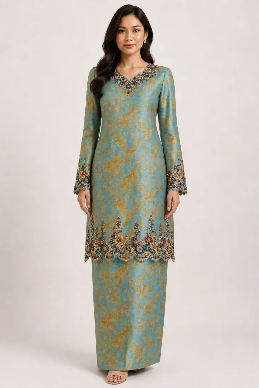 Malam kurung in teal gold songket silk with jewelled neckline and hem